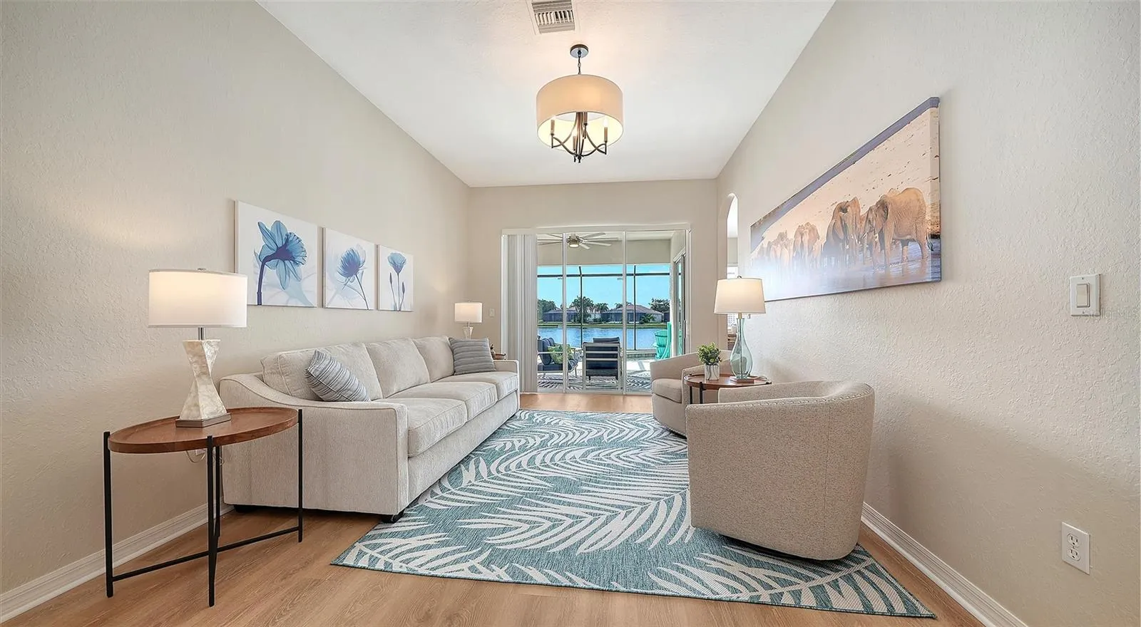 Formal living room with view of pool and pond