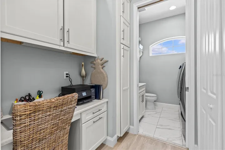 Built in Desk Next to Kitchen.. Leads into half bath/laundry room