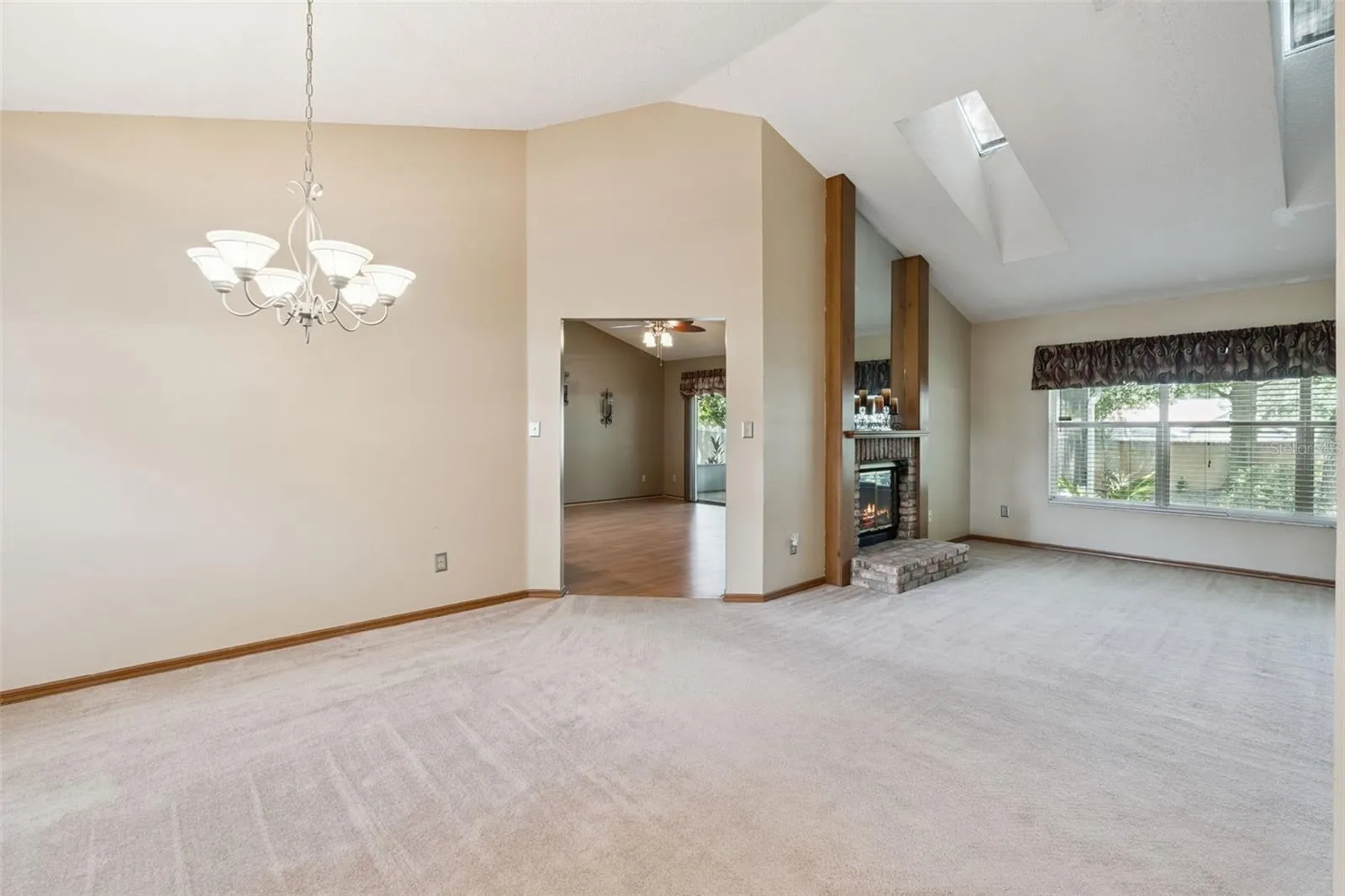 A sneak peak view of the living room and wood burning fireplace.