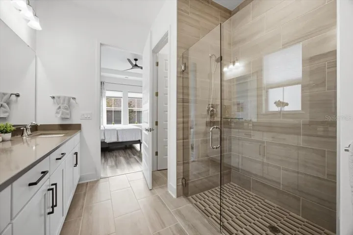 Beautiful primary bathroom with an oversized glass-enclosed walk-in shower
