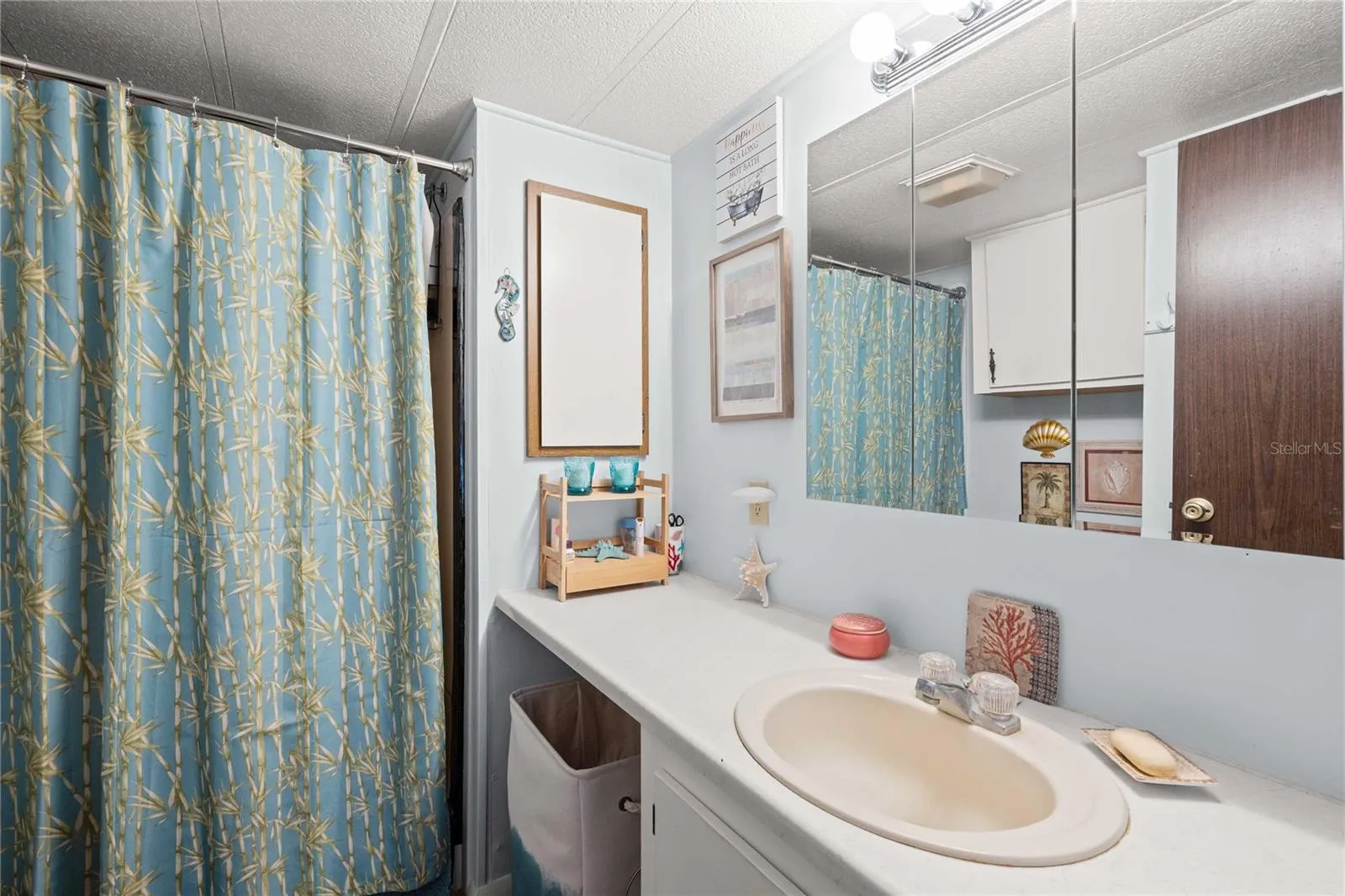 The primary bath has a high vanity and walk in shower
