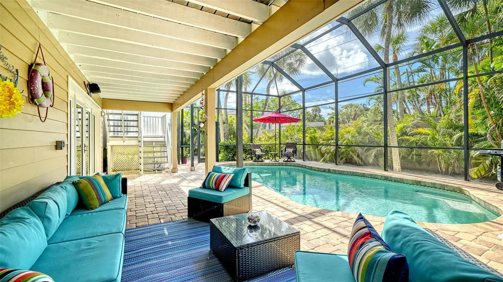 Covered outdoor living area overlooking the heated saltwater pool.