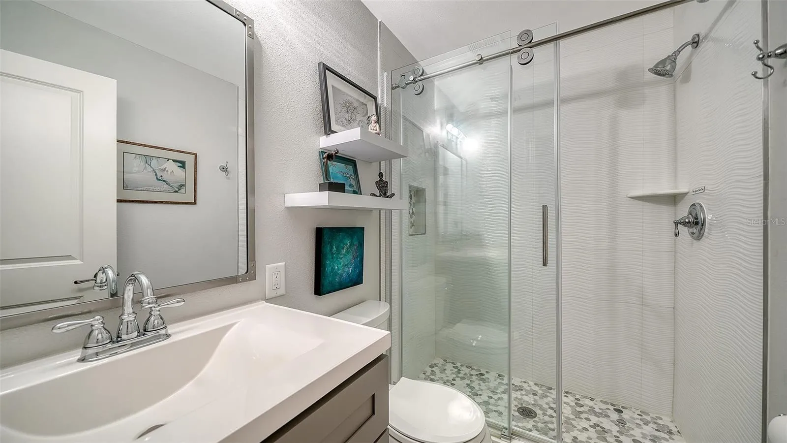Another view of the guest bedroom showcasing its comfortable proportions.