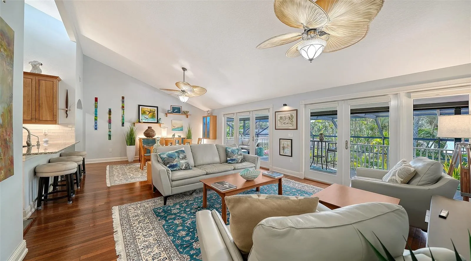 Spacious living room filled with natural light and opening to the covered balcony.
