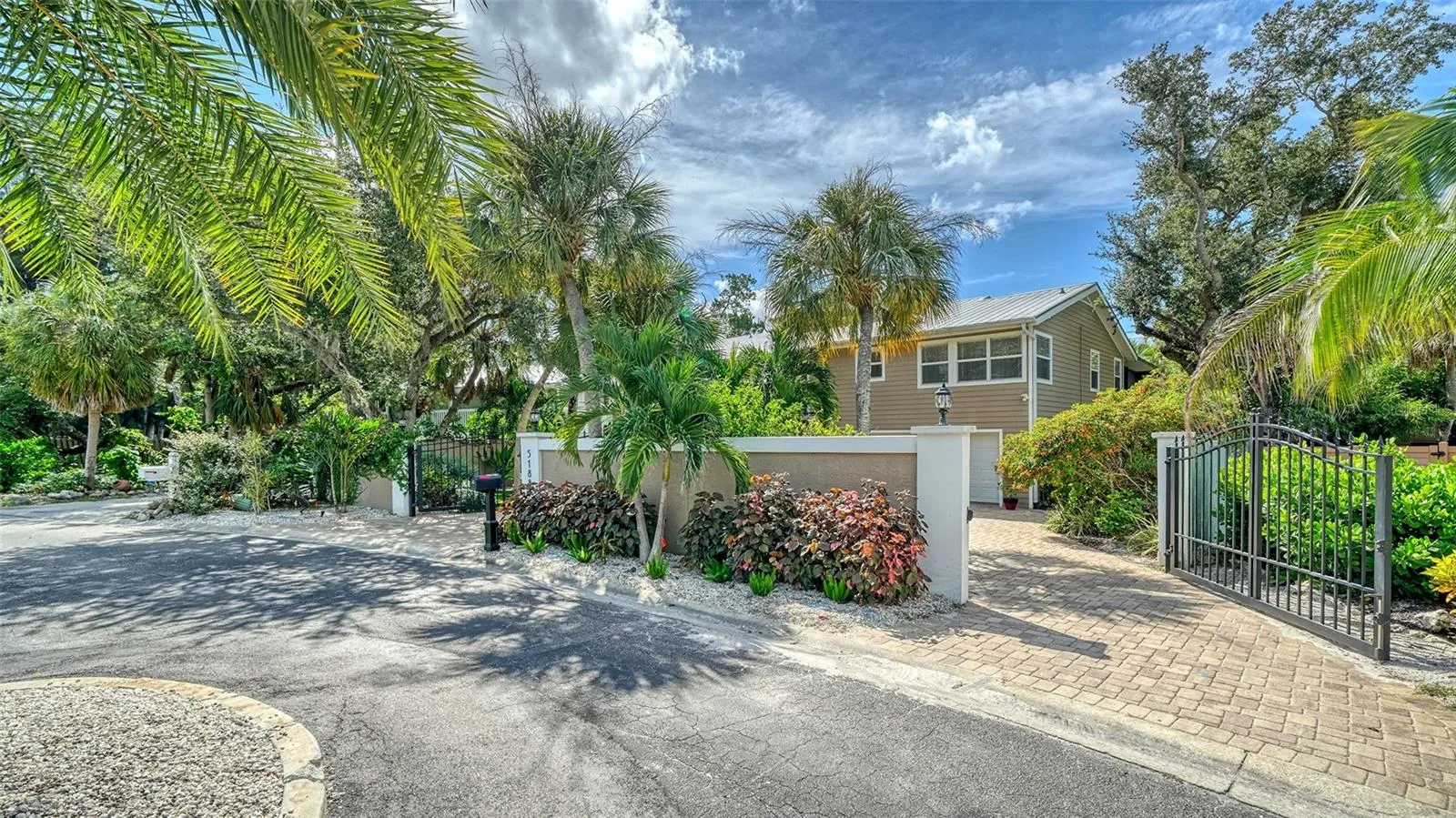 Beautifully landscaped entrance with gated access and a private setting.