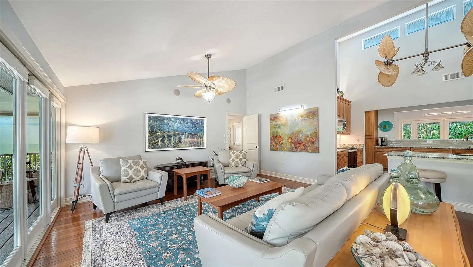 Spacious living room with hardwood floors and access to the covered balcony.