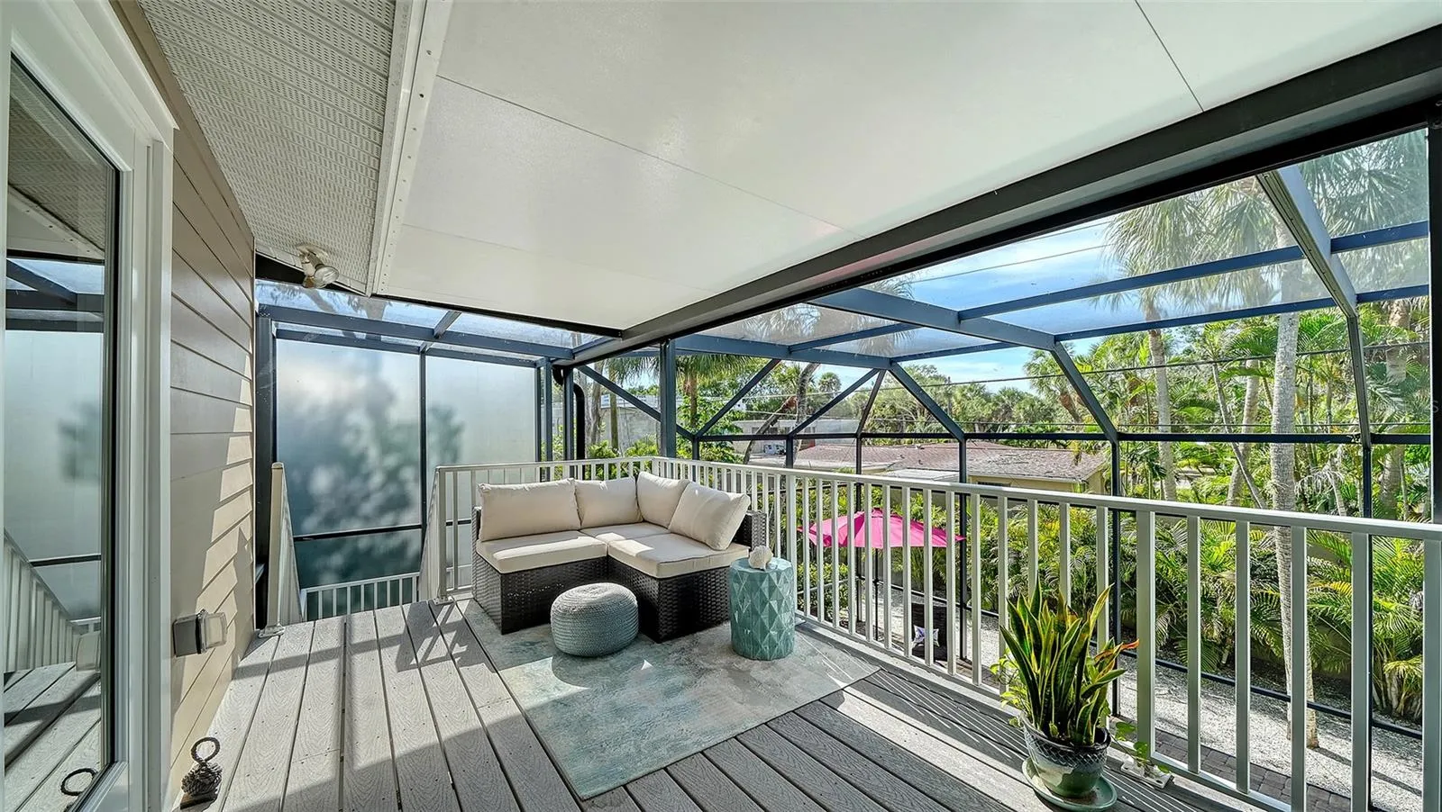 Another inviting screened balcony provides a peaceful place to enjoy the tropical surroundings.