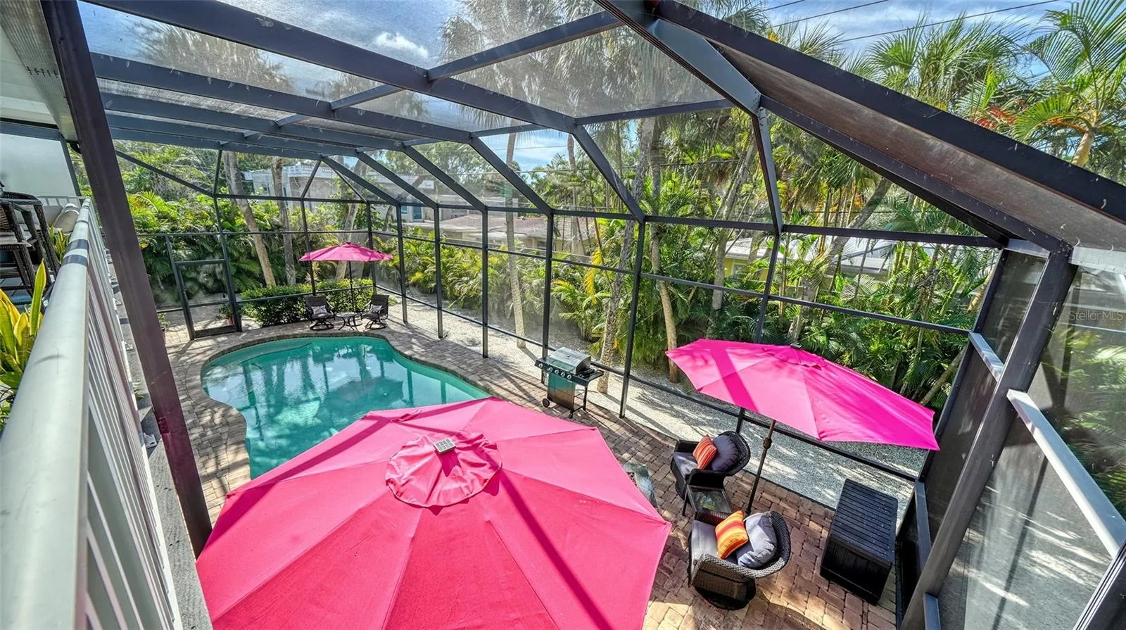 Elevated view overlooking the heated pool and expansive screened lanai.