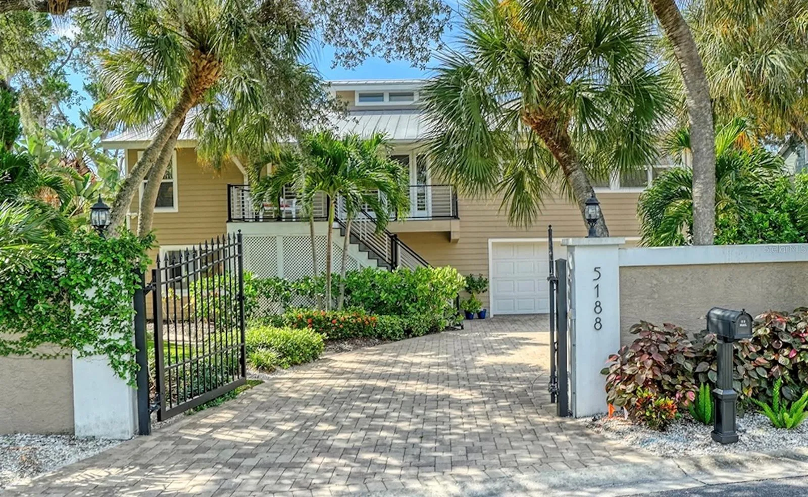 Welcome to 5188 Siesta Woods Drive, a private Siesta Key retreat surrounded by lush tropical landscaping.