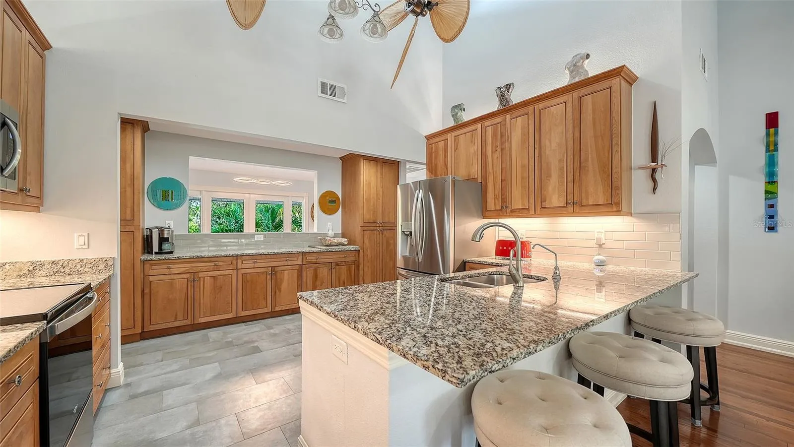 Kitchen opens directly to the main living spaces for effortless entertaining.Remodeled kitchen with granite countertops, custom cabinetry and stainless steel appliances.