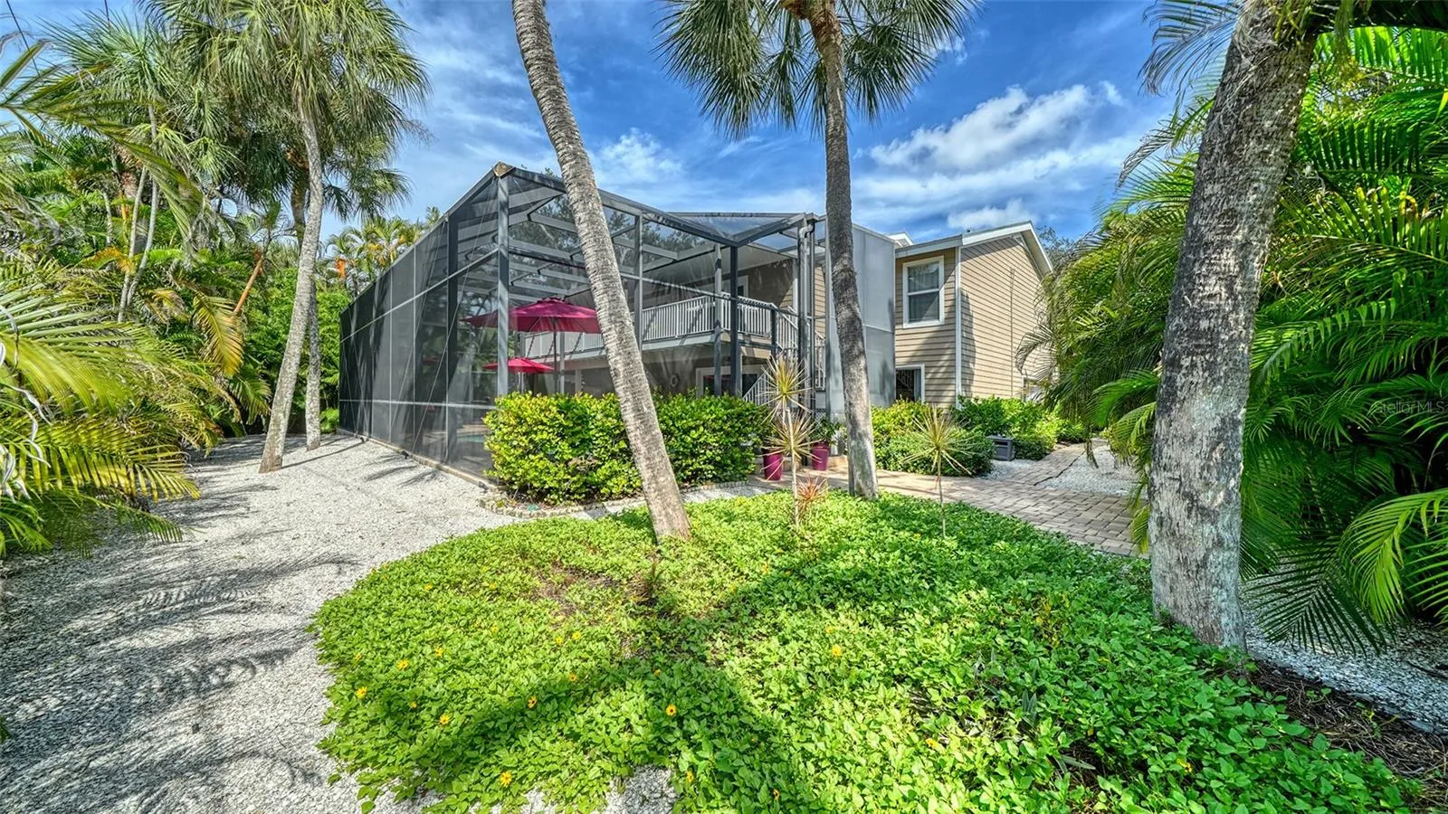 Lush landscaping surrounds the home and enhances its private island setting.