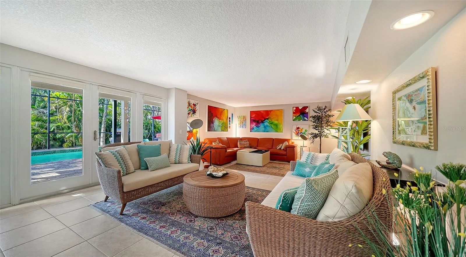 Large lower-level family room with direct access to the screened pool and lanai.