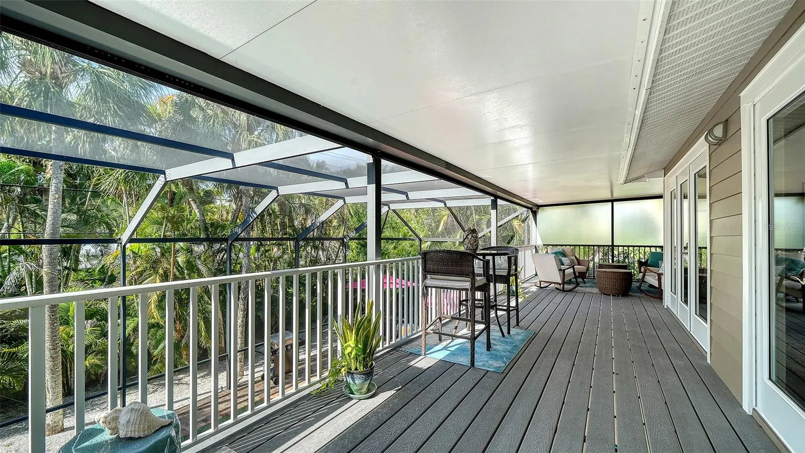 Expansive screened balcony provides additional outdoor living and entertaining space.