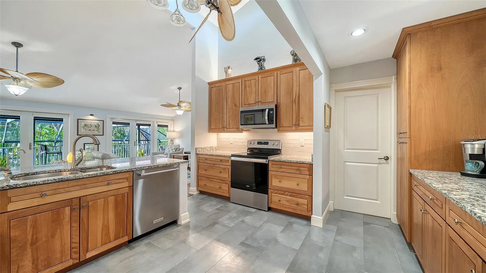 Additional view of the remodeled kitchen with abundant cabinetry and workspace.