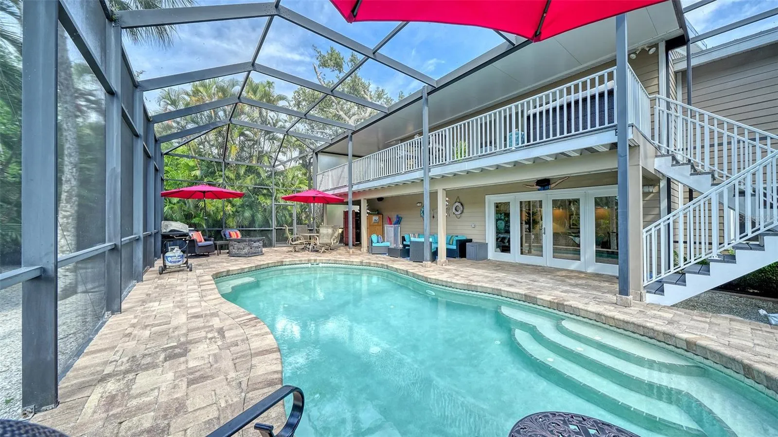 Spacious lower-level living area with French doors opening directly to the pool.