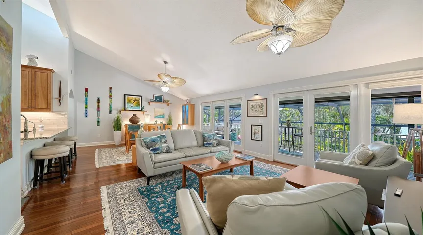 Spacious living room filled with natural light and opening to the covered balcony.