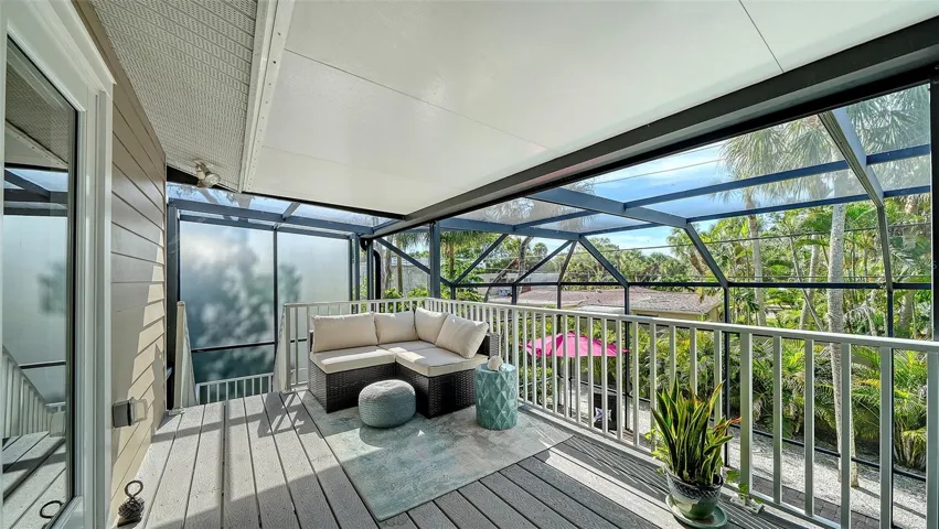 Another inviting screened balcony provides a peaceful place to enjoy the tropical surroundings.