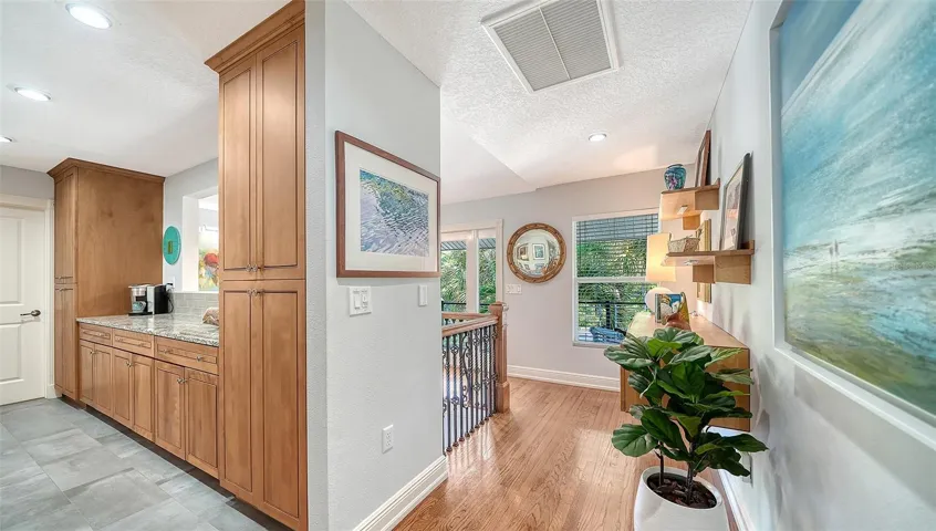Open kitchen with custom wood cabinetry and abundant storage.