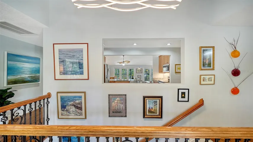 Upper hallway and staircase connecting the home’s two living levels.