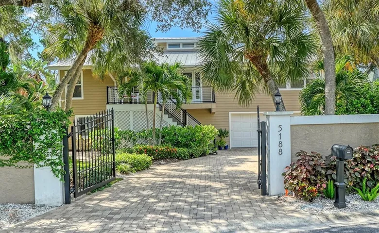 Welcome to 5188 Siesta Woods Drive, a private Siesta Key retreat surrounded by lush tropical landscaping.