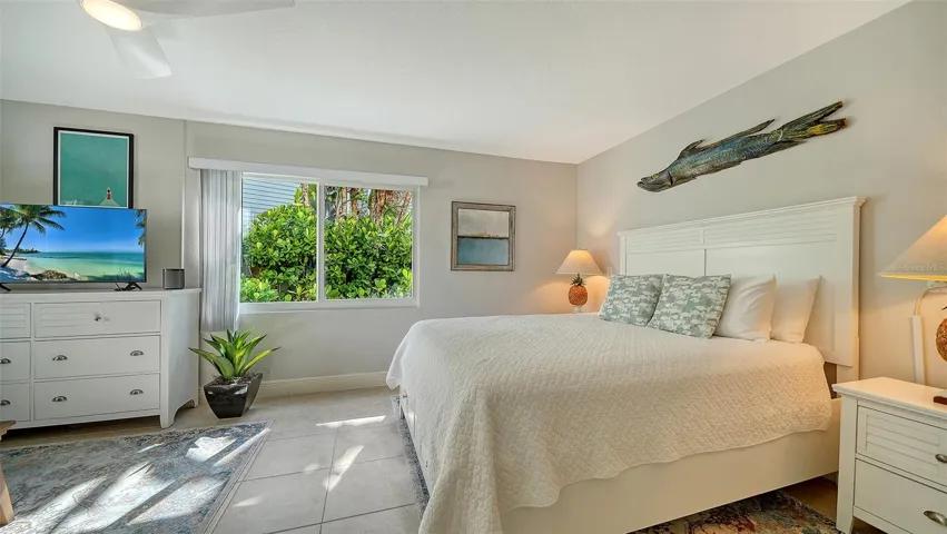 Light-filled bedroom surrounded by tropical views.