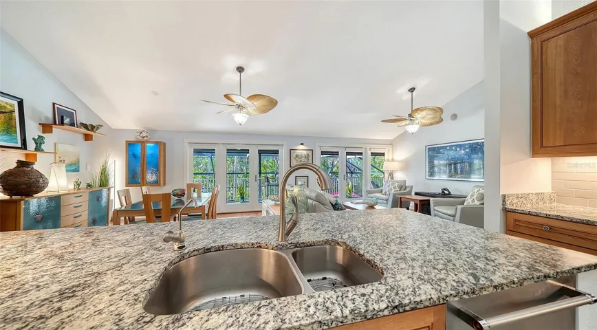 Generous granite breakfast bar provides additional seating and workspace.