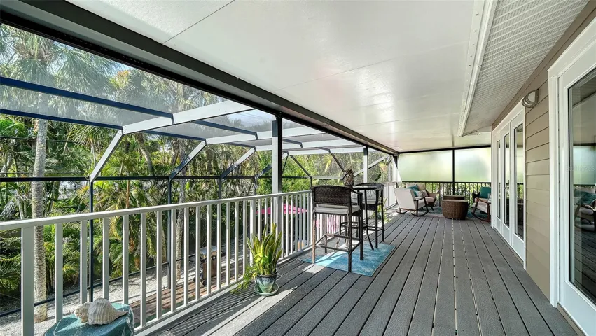 Expansive screened balcony provides additional outdoor living and entertaining space.