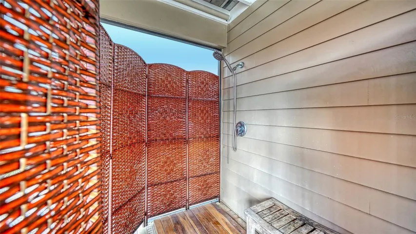 Outdoor shower adds convenience after a day at the pool or beach.