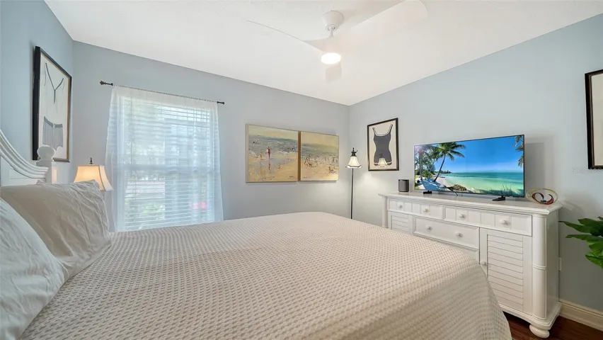 Spacious guest bedroom with ceiling fan and generous closet space.