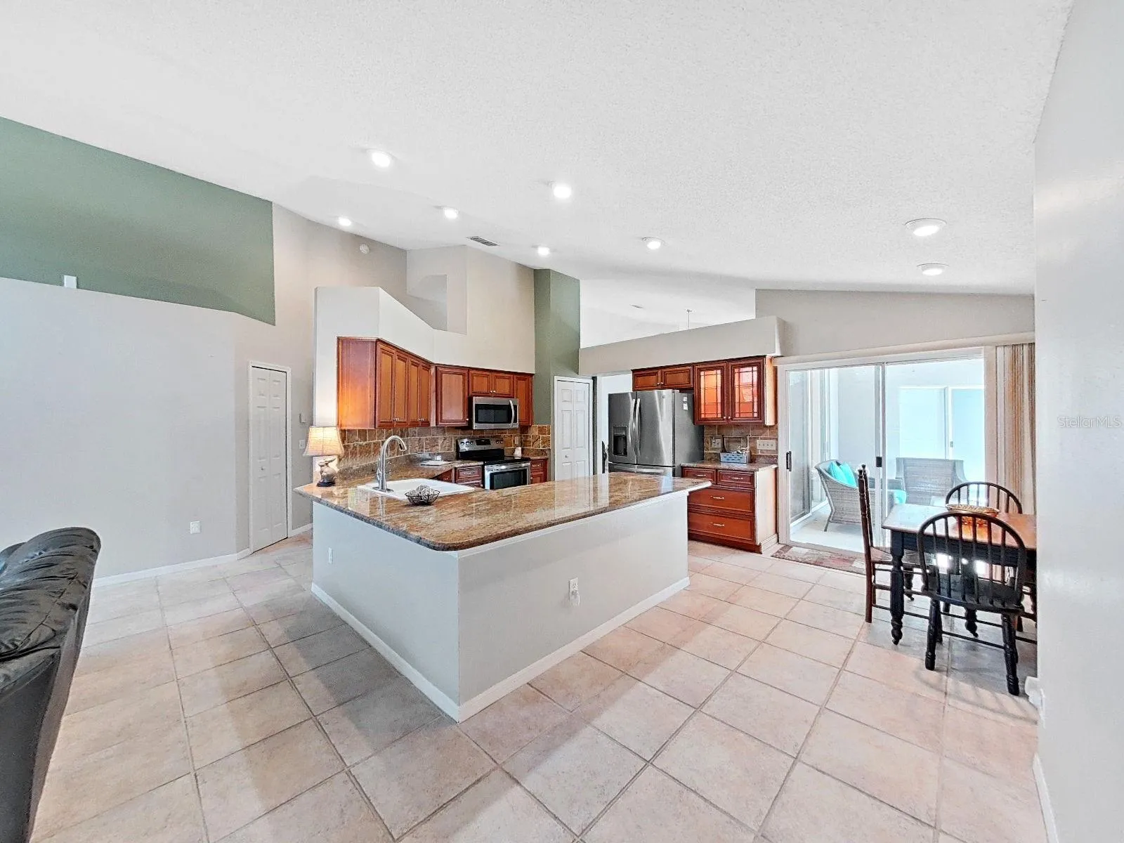 updated kitchen with granite countertops, stainless appliances, recessed lighting