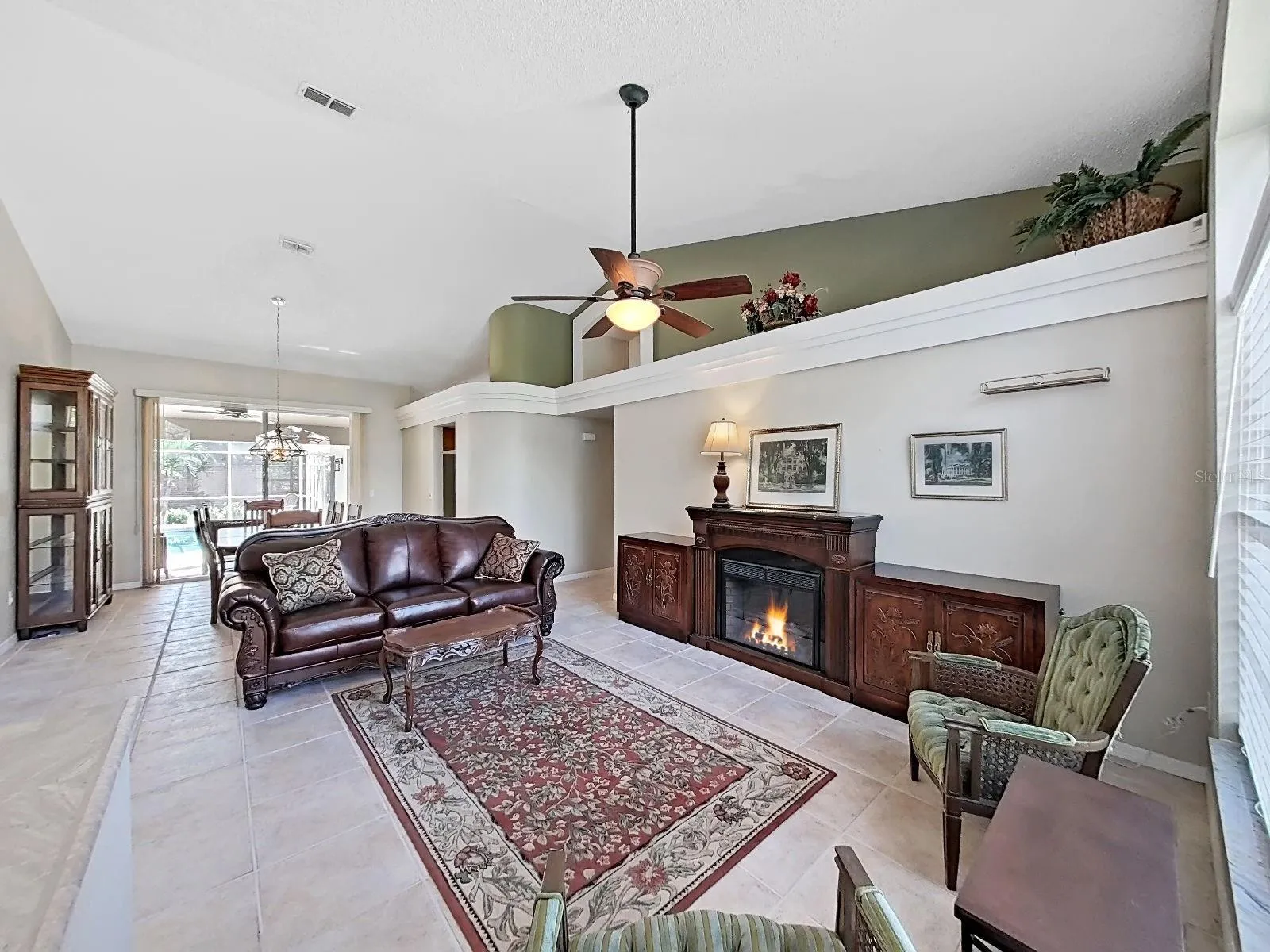 view front door: living and dining rooms, view of covered patio and screened-in pool