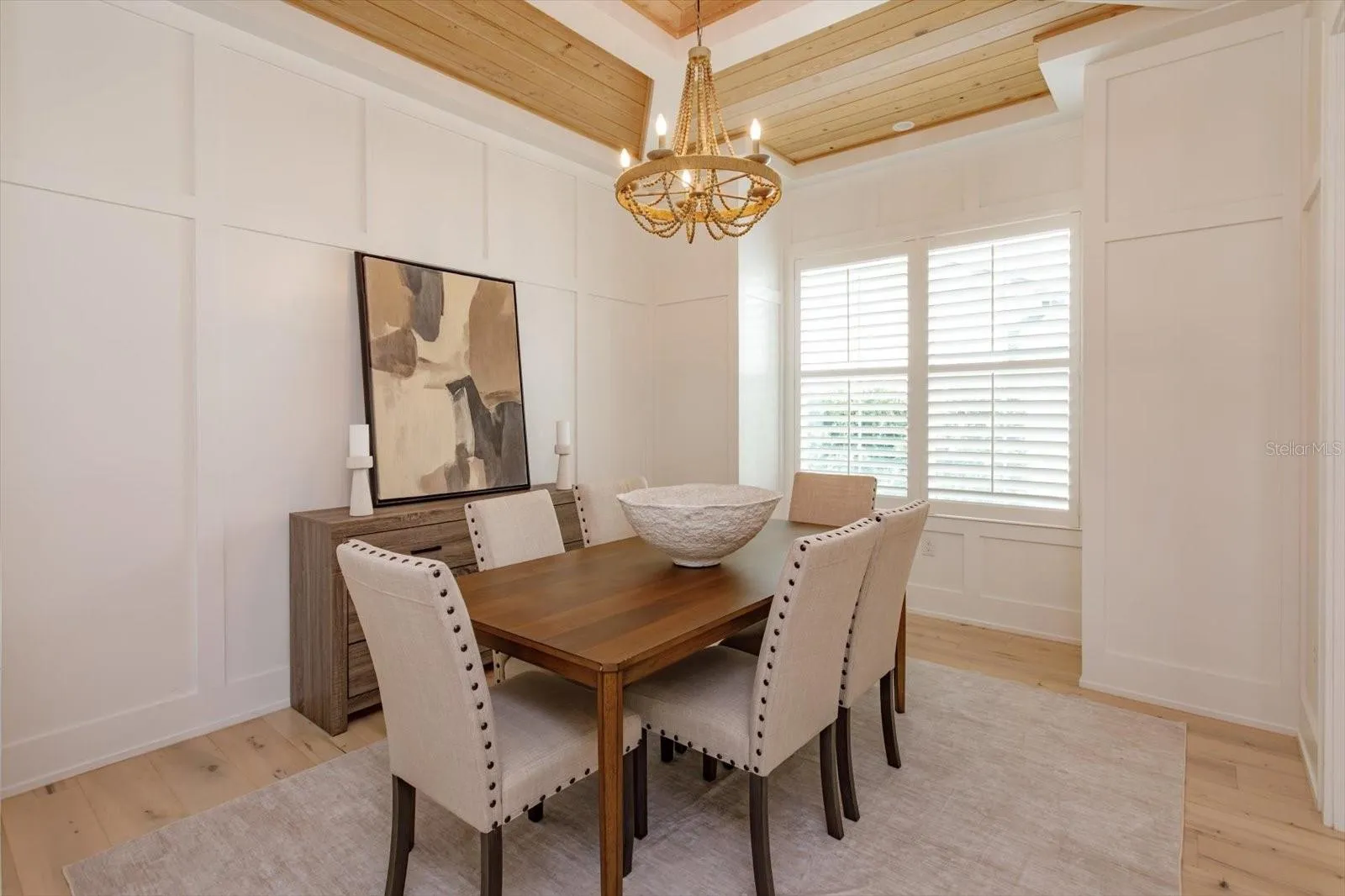 Dining room with wainscoting and tray ceiling