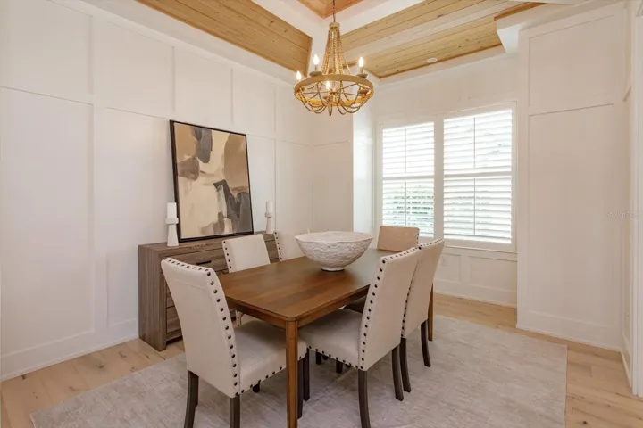 Dining room with wainscoting and tray ceiling