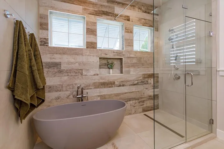 Primary bath with soaking tub and seamless glass shower
