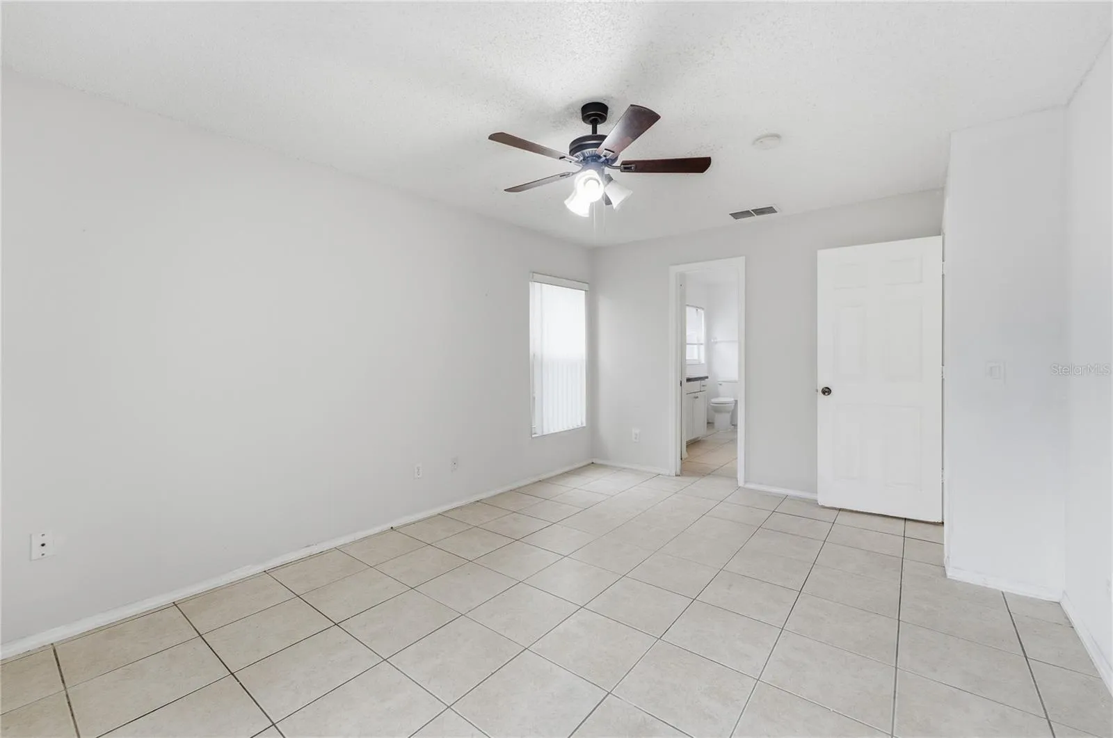 Spacious primary bedroom ready for your personal touch