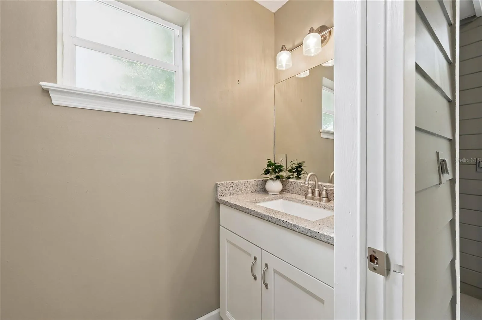 Second 1/2 bath located off the enclosed porch.