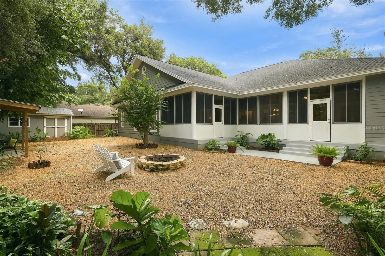 The oversized, fully fenced yard also includes a convenient storage shed and plenty of open space, all complemented by the home’s extensive porch and patio.