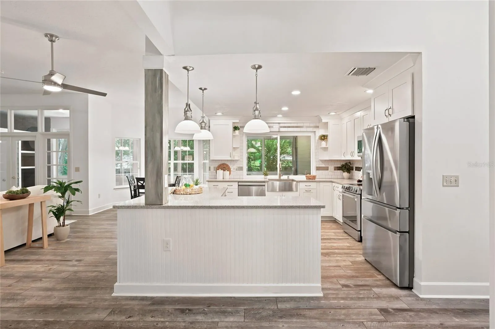 A center island anchors the kitchen, providing abundant workspace with pendant lighting.