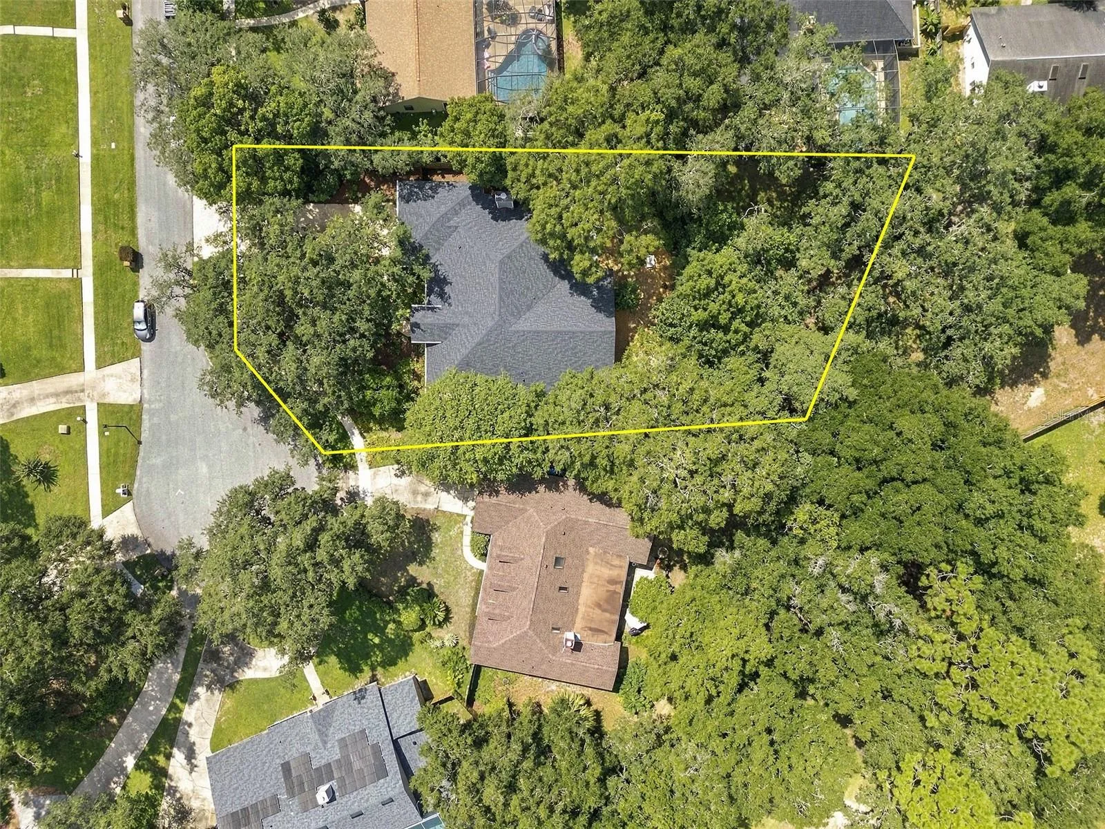 An aerial view highlights the home’s impressive .37 acre homesite, surrounded by a magnificent canopy of mature trees that creates exceptional privacy and a peaceful natural setting.