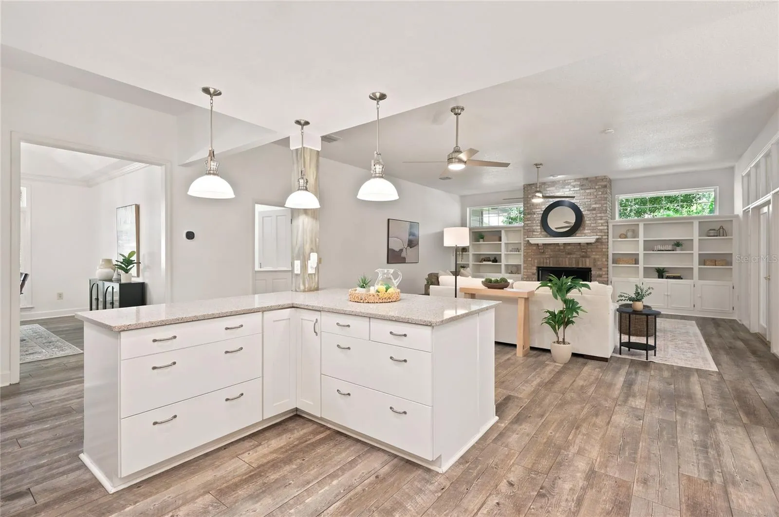 A spacious island that opens effortlessly to the adjoining living areas and offers additional storage and workspace.