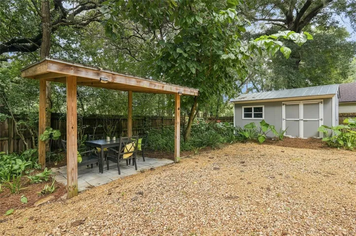 A covered pergola provides a dedicated area for el-fresco dining and entertaining.