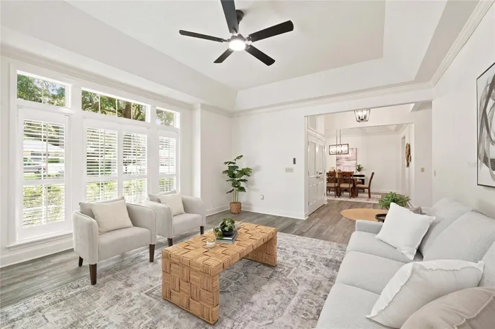 Tray ceilings, elegant crown molding, wood-look flooring, and
