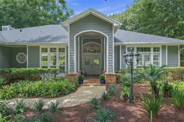 A gracious arched entry framed with classic brick accents creating a warm and welcoming first impression.