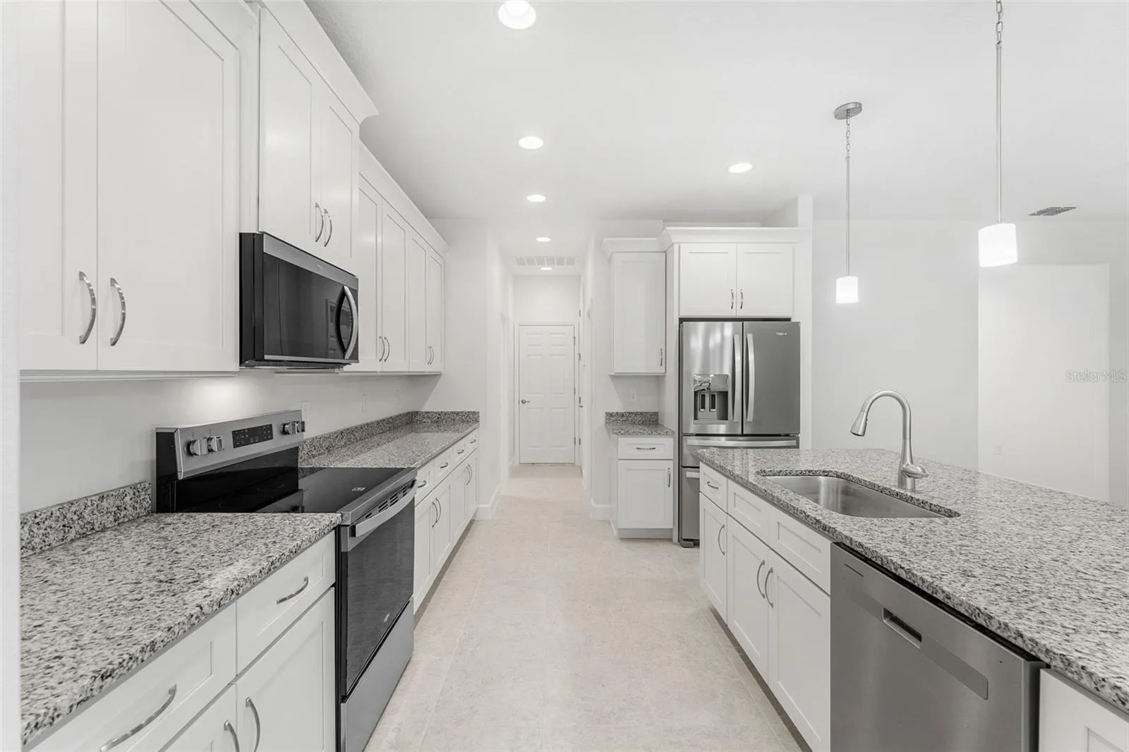 This upgraded home features Granite Countertops, stainless steel appliances, soft close cabinetry, and crown molding.