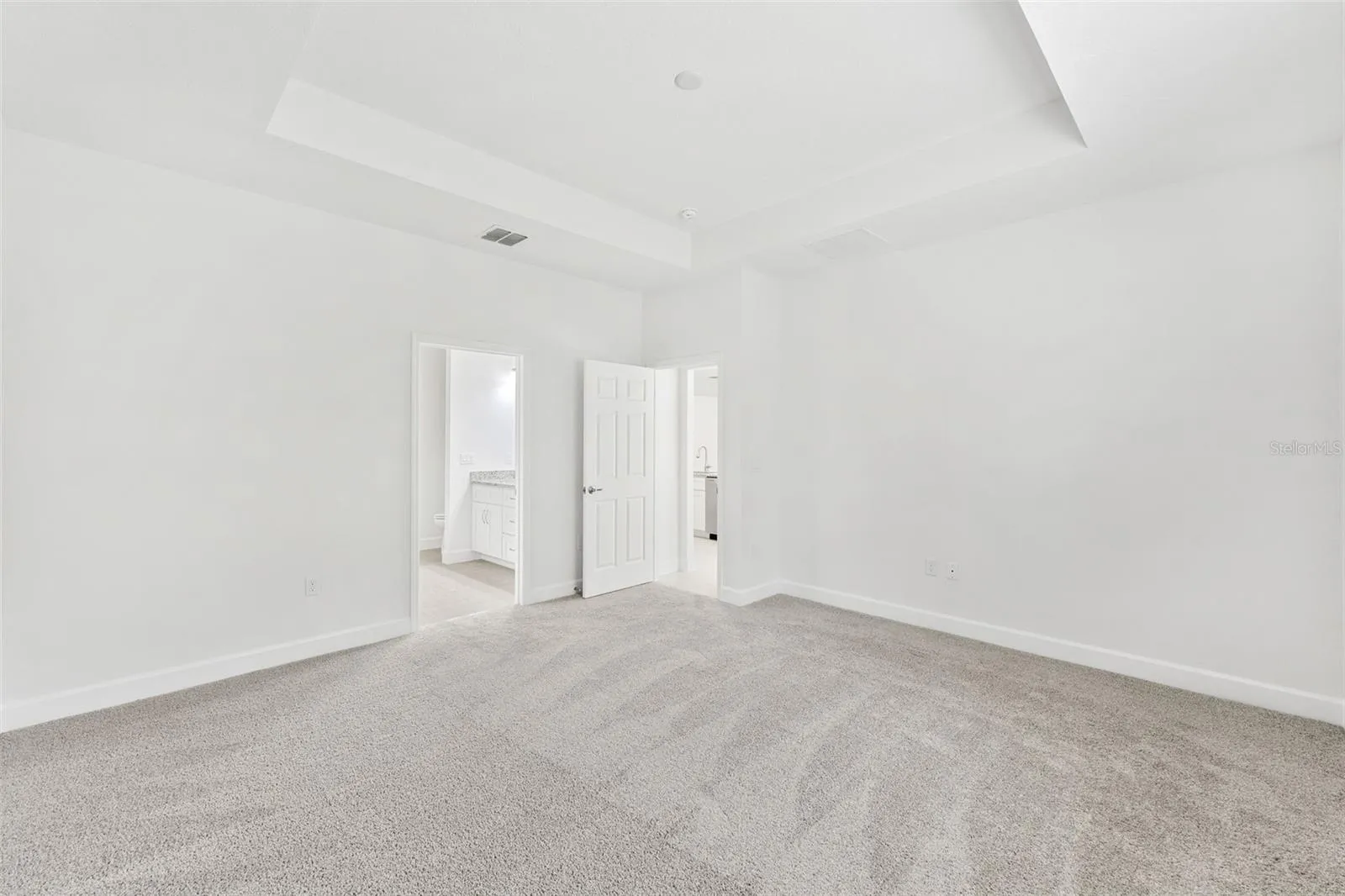 The Primary Bedroom features its own tray ceiling and carpet for added comfort.