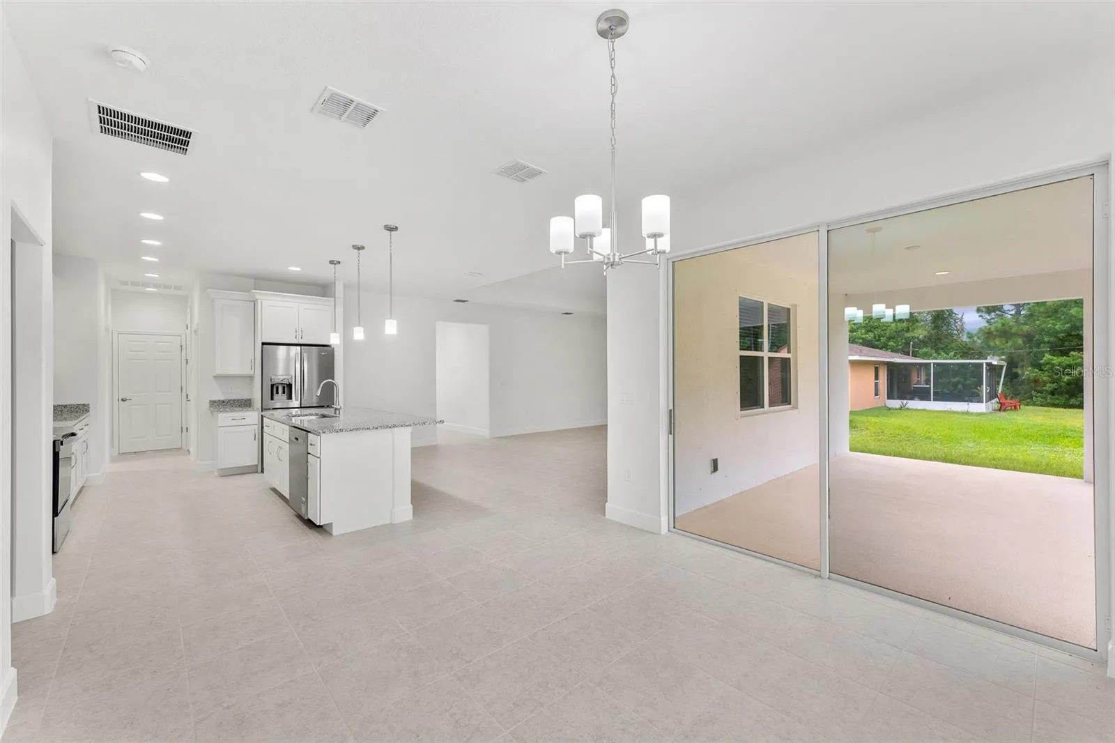 Kitchen with Kitchen Nook and sliding glass door to trussed rear patio