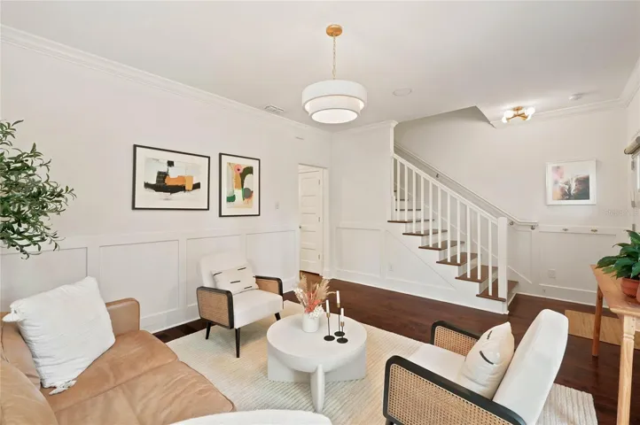 Custom wainscoting, detail moldings and designer light fixture all add to the character of the space