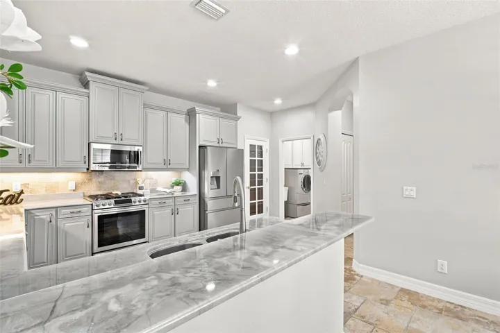 Kitchen bar ... spacious kitchen with lots of room. Plenty of cabinets. Pantry on the right hand side before the laundry room.
