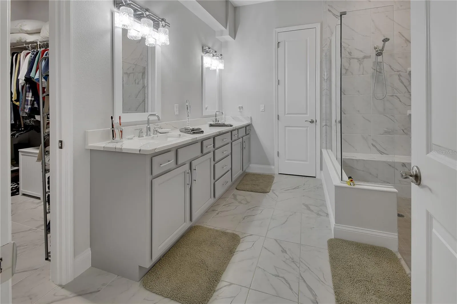 En-suite primary bathroom with linen closet