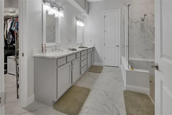 En-suite primary bathroom with linen closet